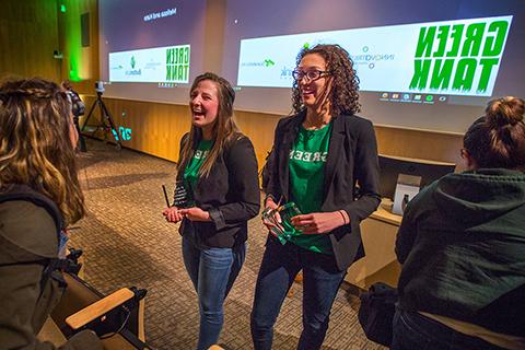 足彩平台 business students Melissa Khalil, left, and Kaitlin Amerling are congratulated on their first-place win in the Green Tank business plan competition for Earth Week.