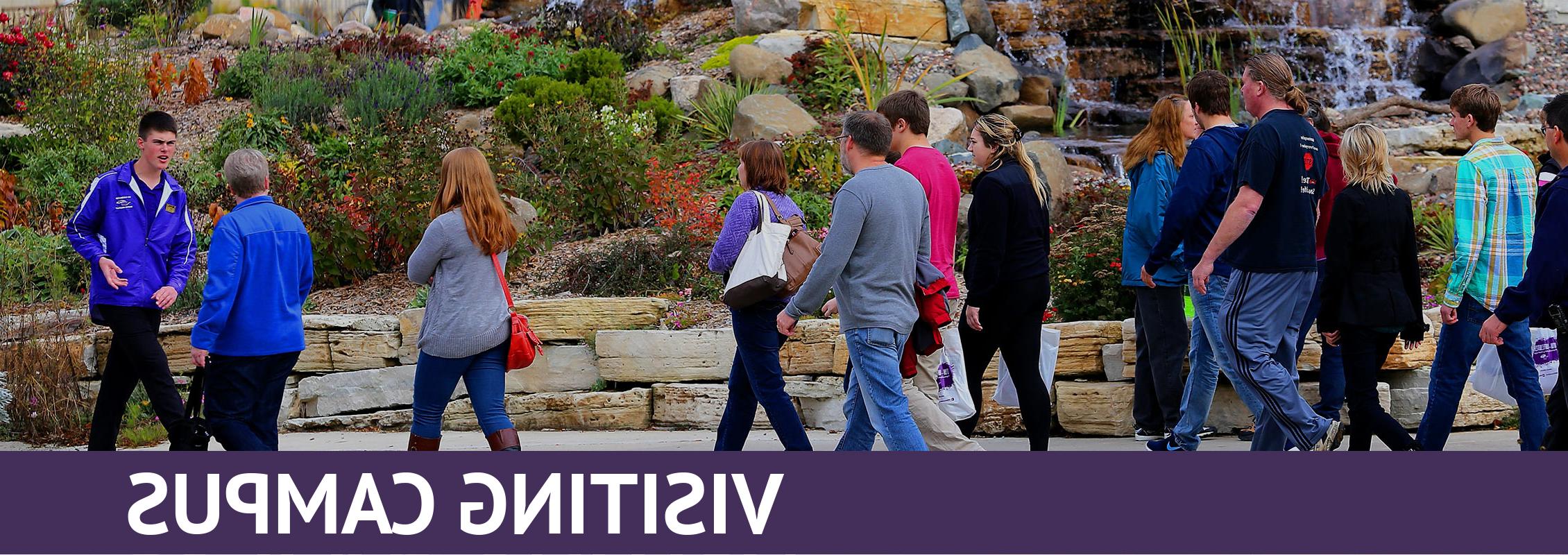 Visiting Campus: Student tour guide leads a group of parents and students