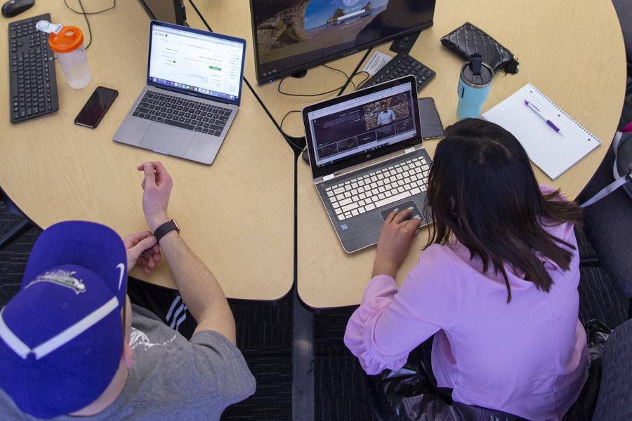 An overhead view of people sitting at computer stations.